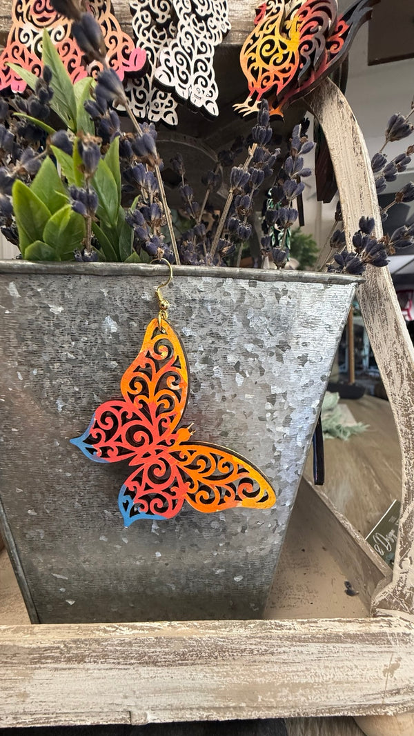 Hand-painted filigree butterfly earring by Wisp & Fern on display