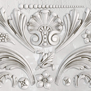 A silicone mould with baroque-inspired floral and scroll details.