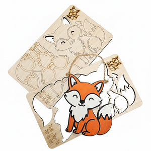 Wooden fox cutout with a hanging string on a textured white surface ready to be painted DIY Kits for kids
