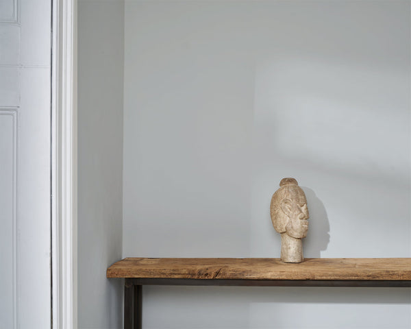 Interior wall painted in Annie Sloan Paled Mallow with a rustic wood console