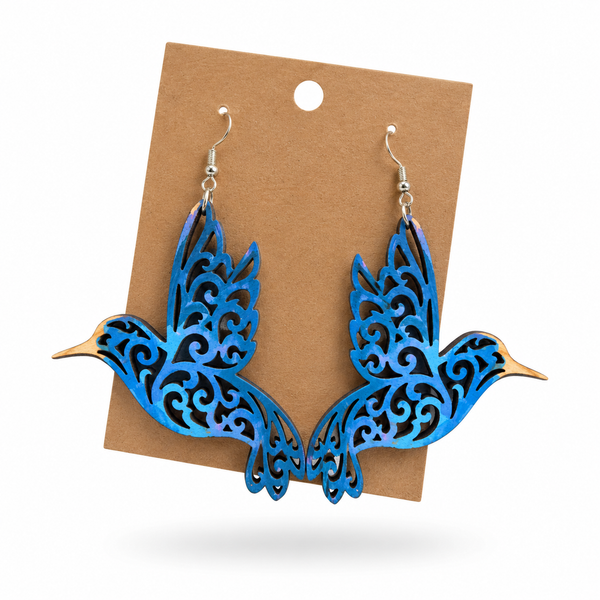 Blue Filigree Hummingbird Earrings displayed on a kraft earring card