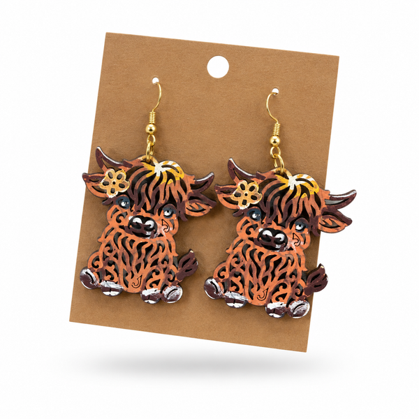 Highland Cow Filigree Earrings displayed on a kraft earring card