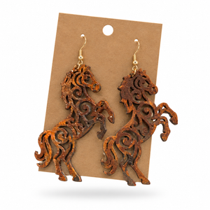 Rearing Rusty Iron Horse Filigree Earrings displayed on a kraft earring card