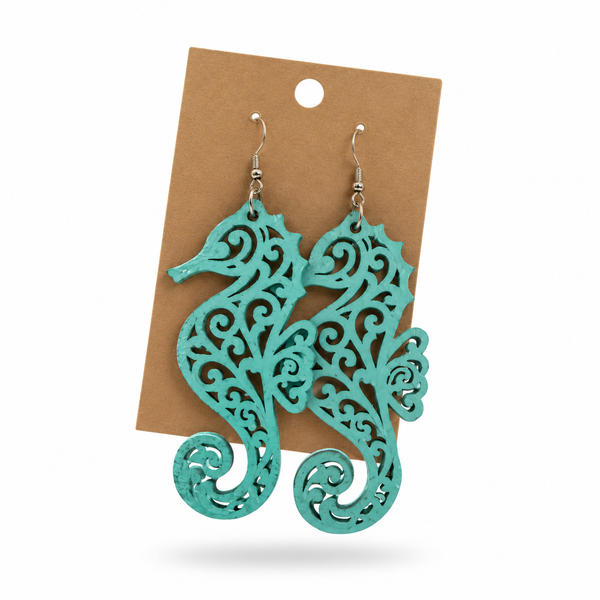 Teal Seahorse Filigree Earrings displayed on a kraft earring card