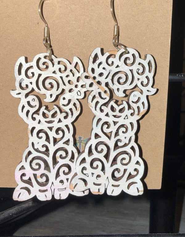 White filigree llama earrings by Wisp & Fern on a display card